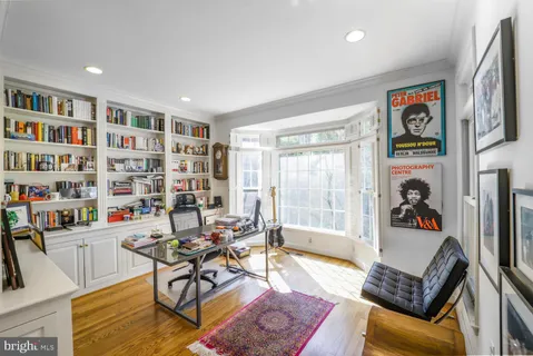 a living room with furniture and a book shelf