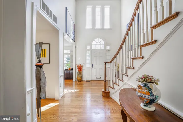 a view of entryway and hall with wooden floor