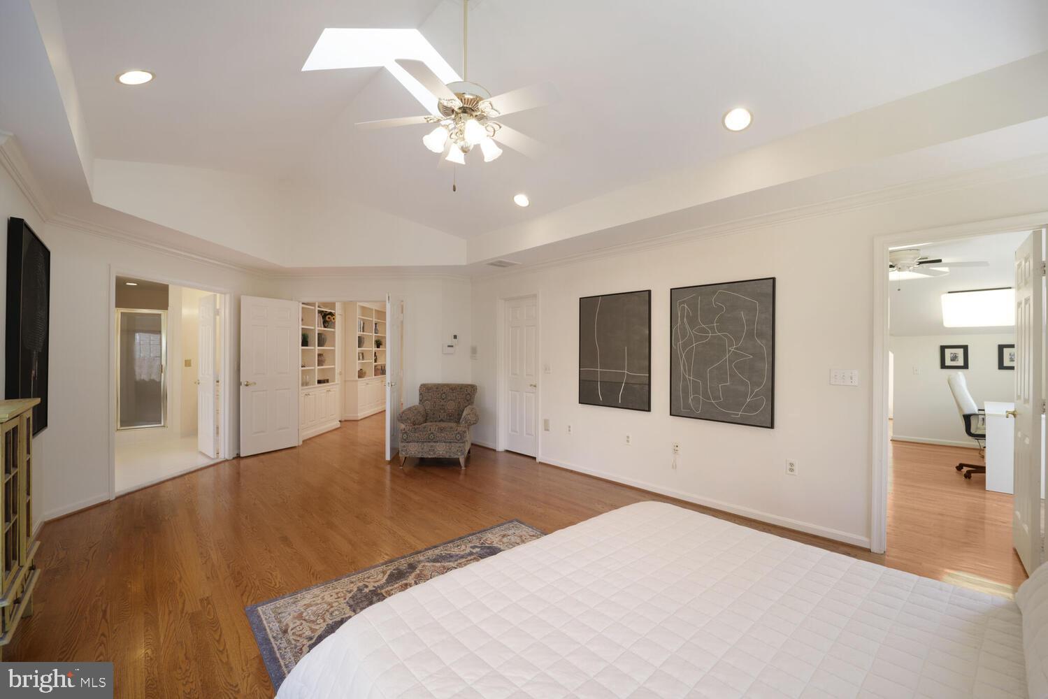5119 Warren Place Northwest Washington, DC 20016 - Photo 24 of 37 a spacious bedroom with a bed and a chandelier