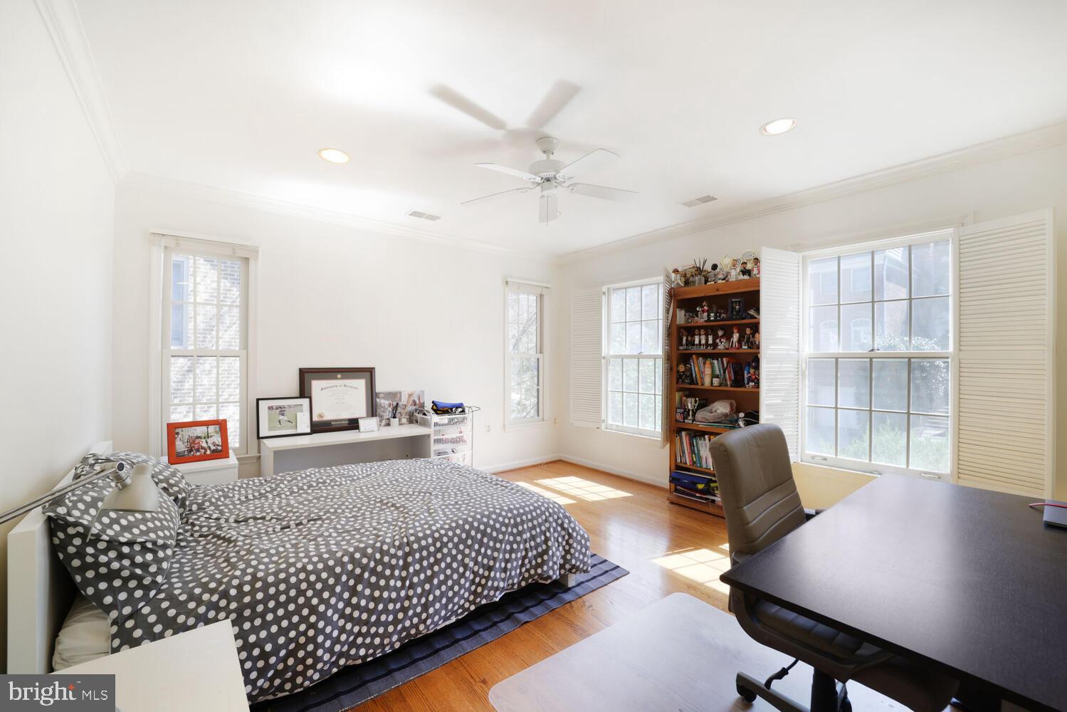 5119 Warren Place Northwest Washington, DC 20016 - Photo 29 of 37 a bedroom with a bed a table and a large window