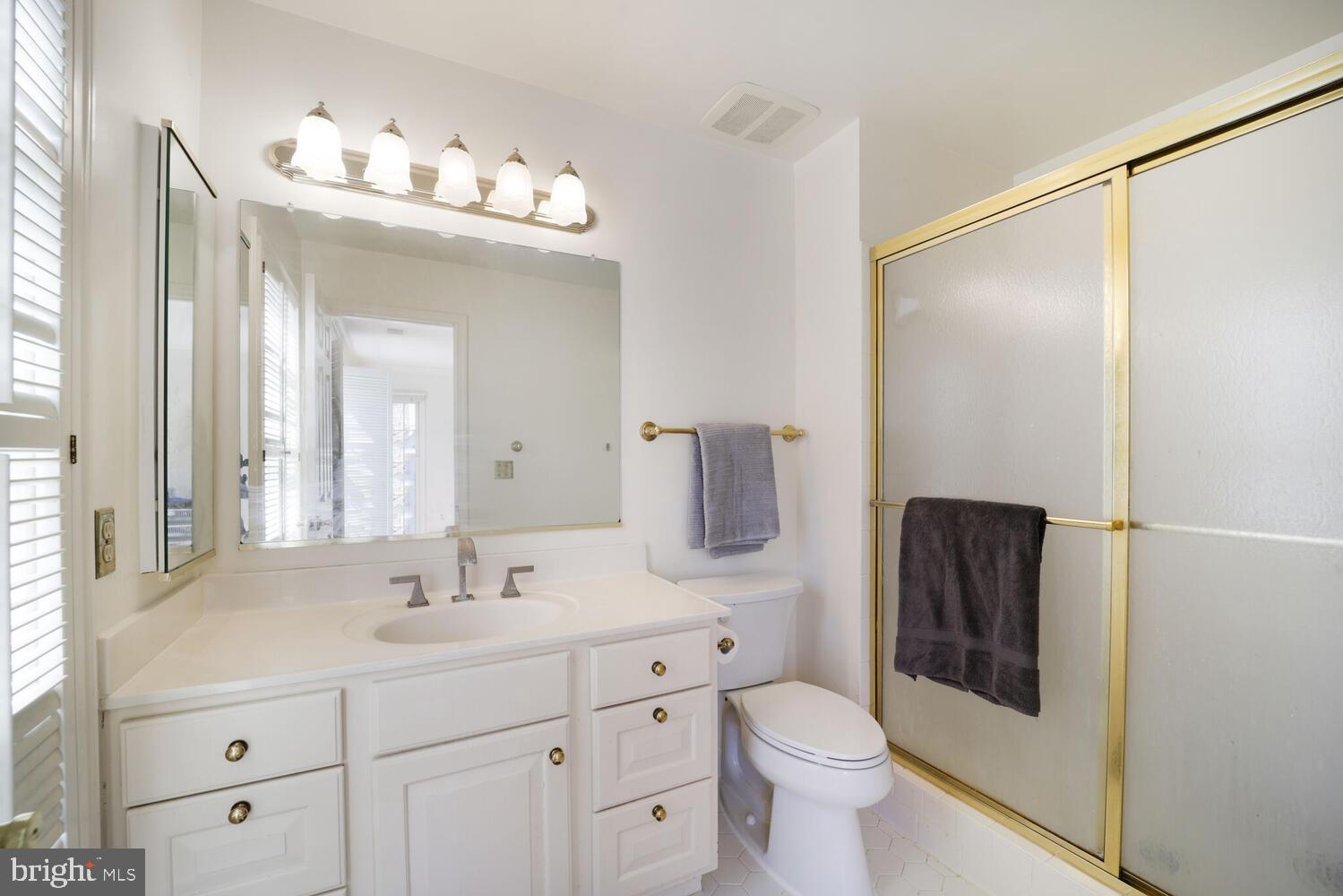 5119 Warren Place Northwest Washington, DC 20016 - Photo 30 of 37 a bathroom with a toilet sink and mirror