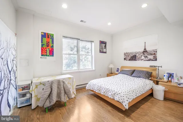 a bedroom with a bed and a couch