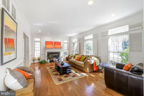 a living room with furniture a rug and a flat screen tv