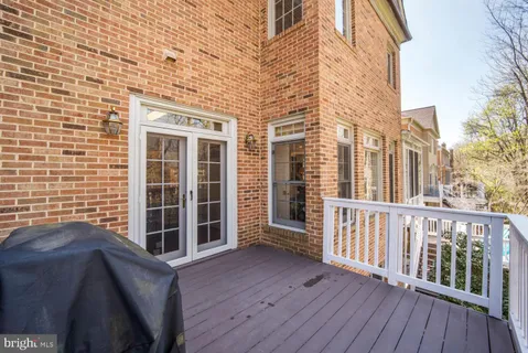 a view of a balcony with wooden floor and fence