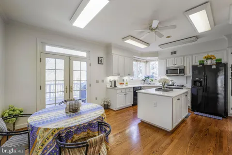 a kitchen with a table chairs refrigerator and microwave