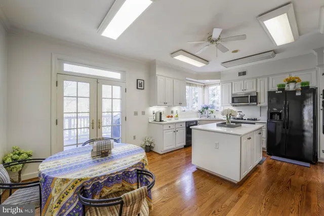 a kitchen with a table chairs refrigerator and microwave