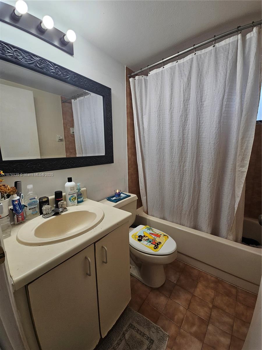 5350 West 21st Court, Unit 407 Hialeah, FL 33016 - Photo 11 of 15 a bathroom with a sink a toilet and a mirror