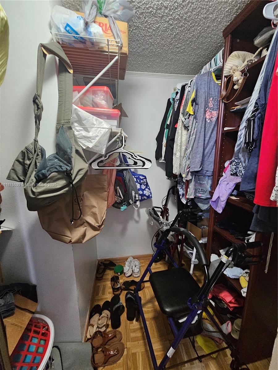 5350 West 21st Court, Unit 407 Hialeah, FL 33016 - Photo 12 of 15 a room with lots of different colored cloths