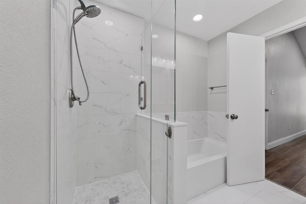7729 Misty Ridge Drive North Fort Worth, TX 76137 - Photo 17 of 30 a bathroom with a glass shower door