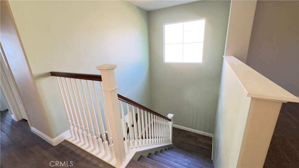 3687 White Ash Road San Bernardino, CA 92407 - Photo 14 of 29 a view of a hallway with wooden floor and windows