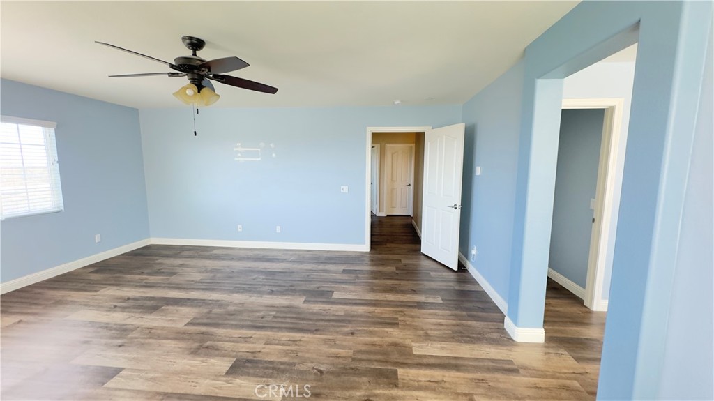 3687 White Ash Road San Bernardino, CA 92407 - Photo 20 of 29 a view of a room with wooden floor and a ceiling fan
