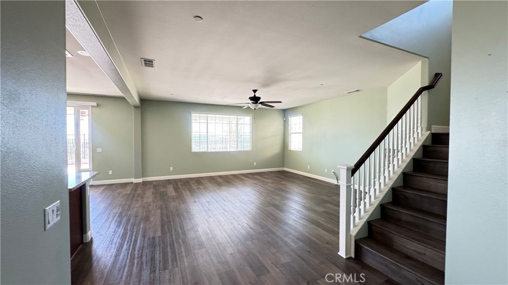3687 White Ash Road San Bernardino, CA 92407 - Photo 6 of 29 a view of an empty room with wooden floor and windows