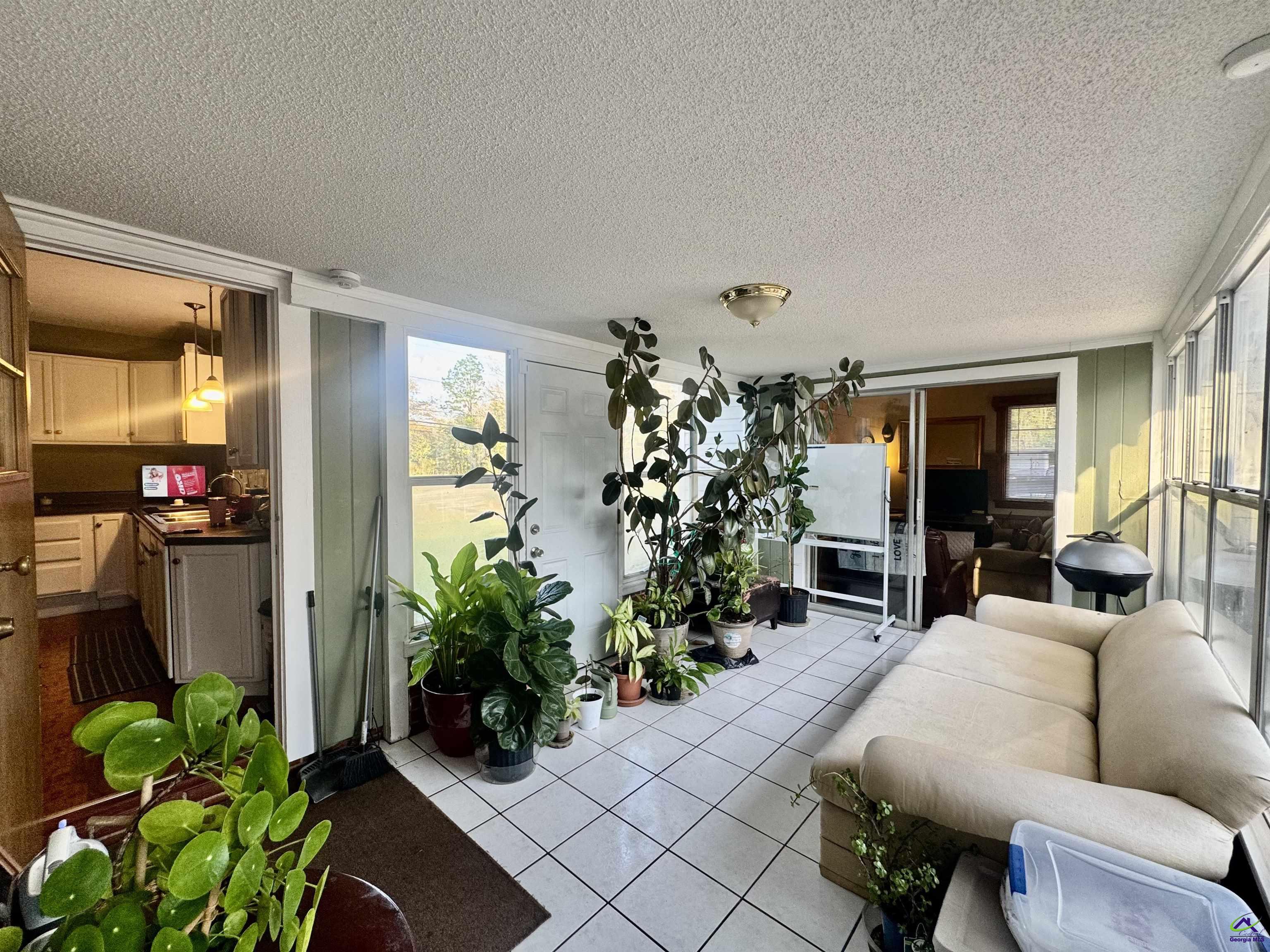 914 Adderton Street Americus, GA 31719 - Photo 40 of 53 a living room with furniture potted plant and a window