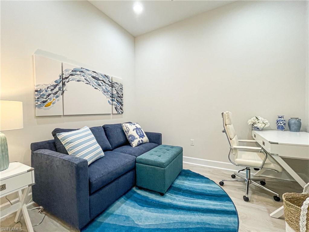 7162 Saona Court Naples, FL 34113 - Photo 12 of 19 a living room with furniture and wooden floor