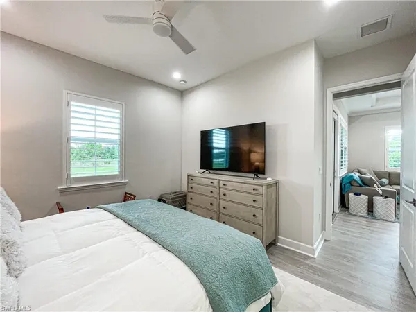 a bedroom with a flat screen television and a bed