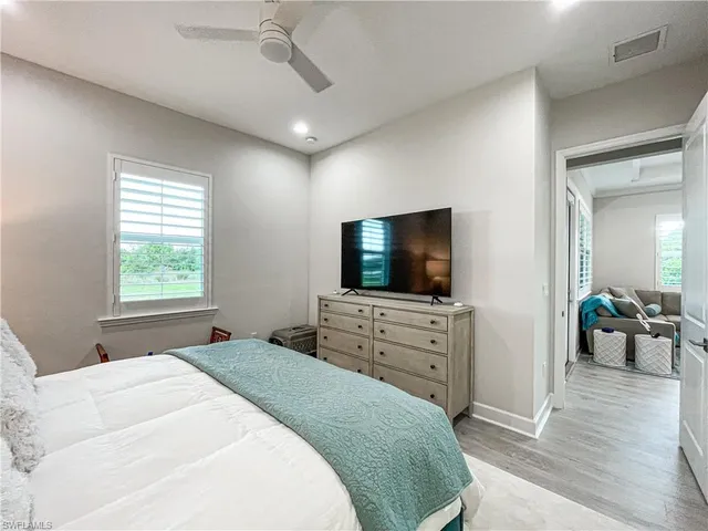 a bedroom with a flat screen television and a bed