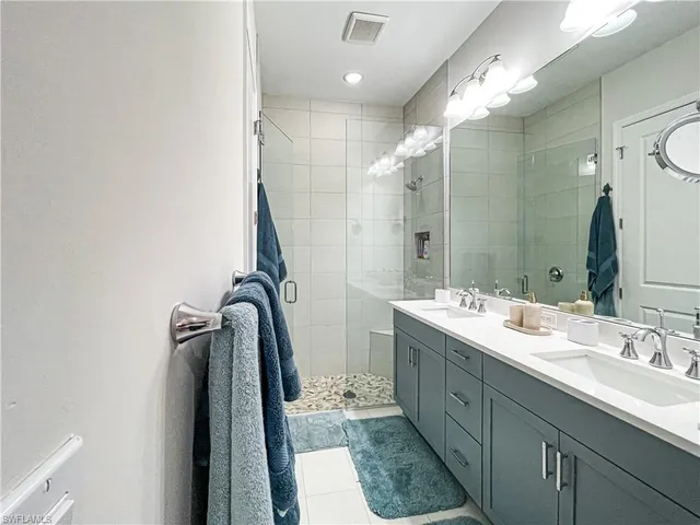 a bathroom with a double vanity sink mirror and double