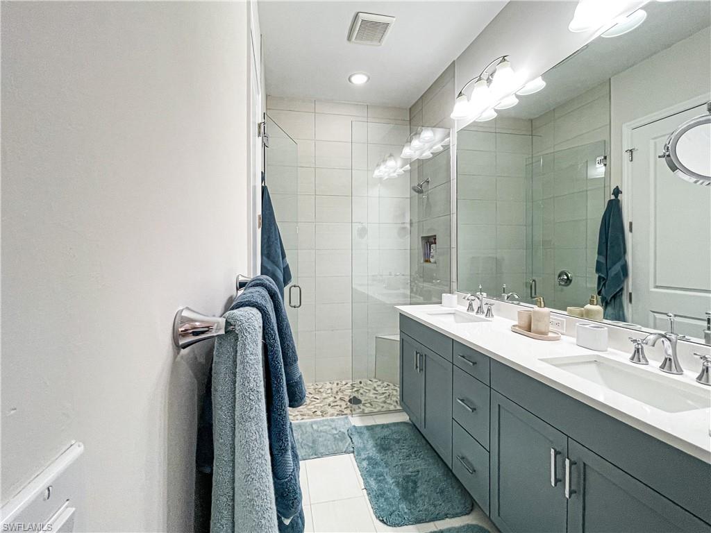 7162 Saona Court Naples, FL 34113 - Photo 17 of 19 a bathroom with a double vanity sink mirror and double