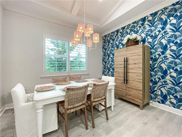 a dining room with furniture and window