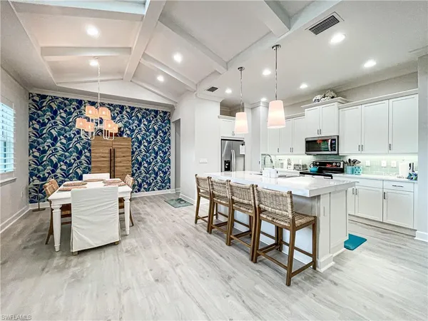 a kitchen with a sink appliances and cabinets