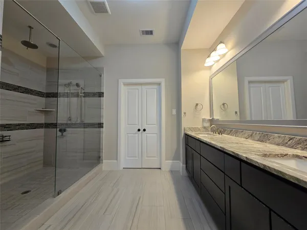 a bathroom with a granite countertop sink mirror and double
