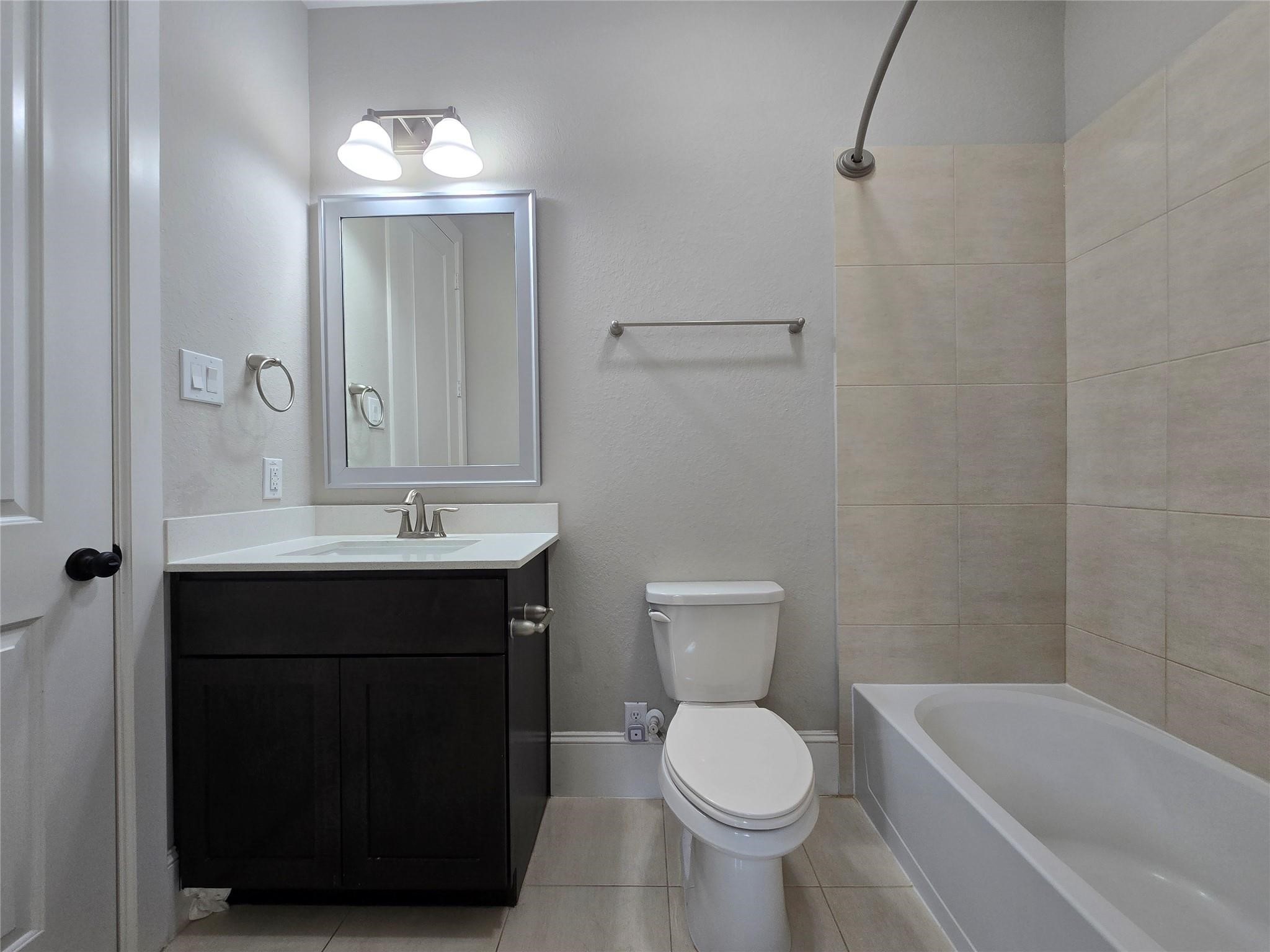 11918 Stirling Row Lane Houston, TX 77082 - Photo 5 of 21 a bathroom with a sink a toilet and bathtub