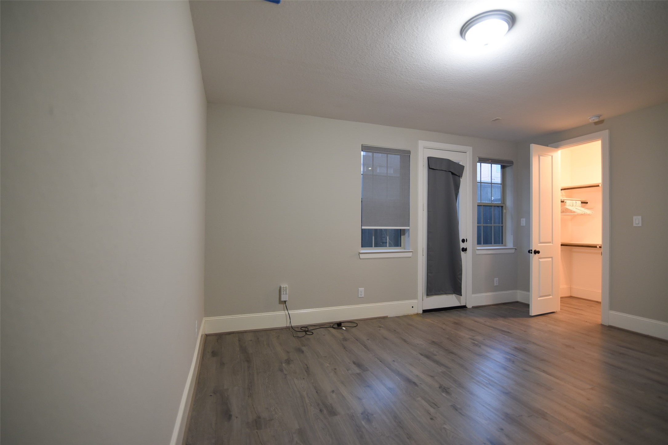 11918 Stirling Row Lane Houston, TX 77082 - Photo 7 of 21 an empty room with wooden floor and windows