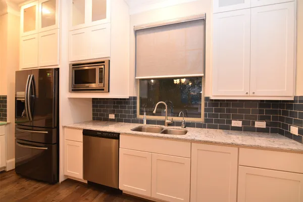 a kitchen with stainless steel appliances white cabinets and a granite counter tops