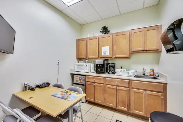 a kitchen with a cabinets appliances and a dining table