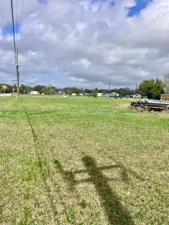 a view of a field with of grass and trees