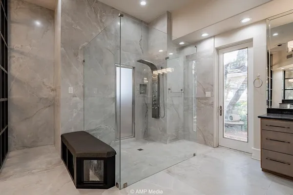 a spacious bathroom with a tub sink and mirror