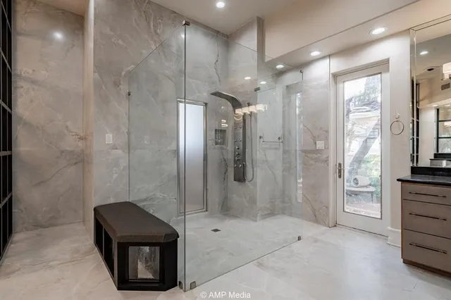 a spacious bathroom with a tub sink and mirror