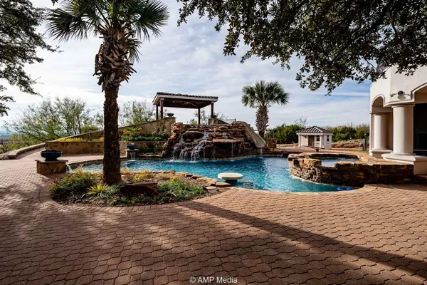 a front view of a house with plants and trees