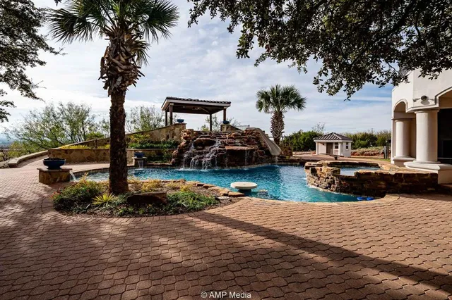 a front view of a house with plants and trees