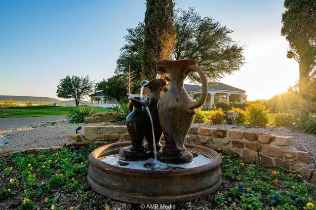 a view of a water fountain in front of a house