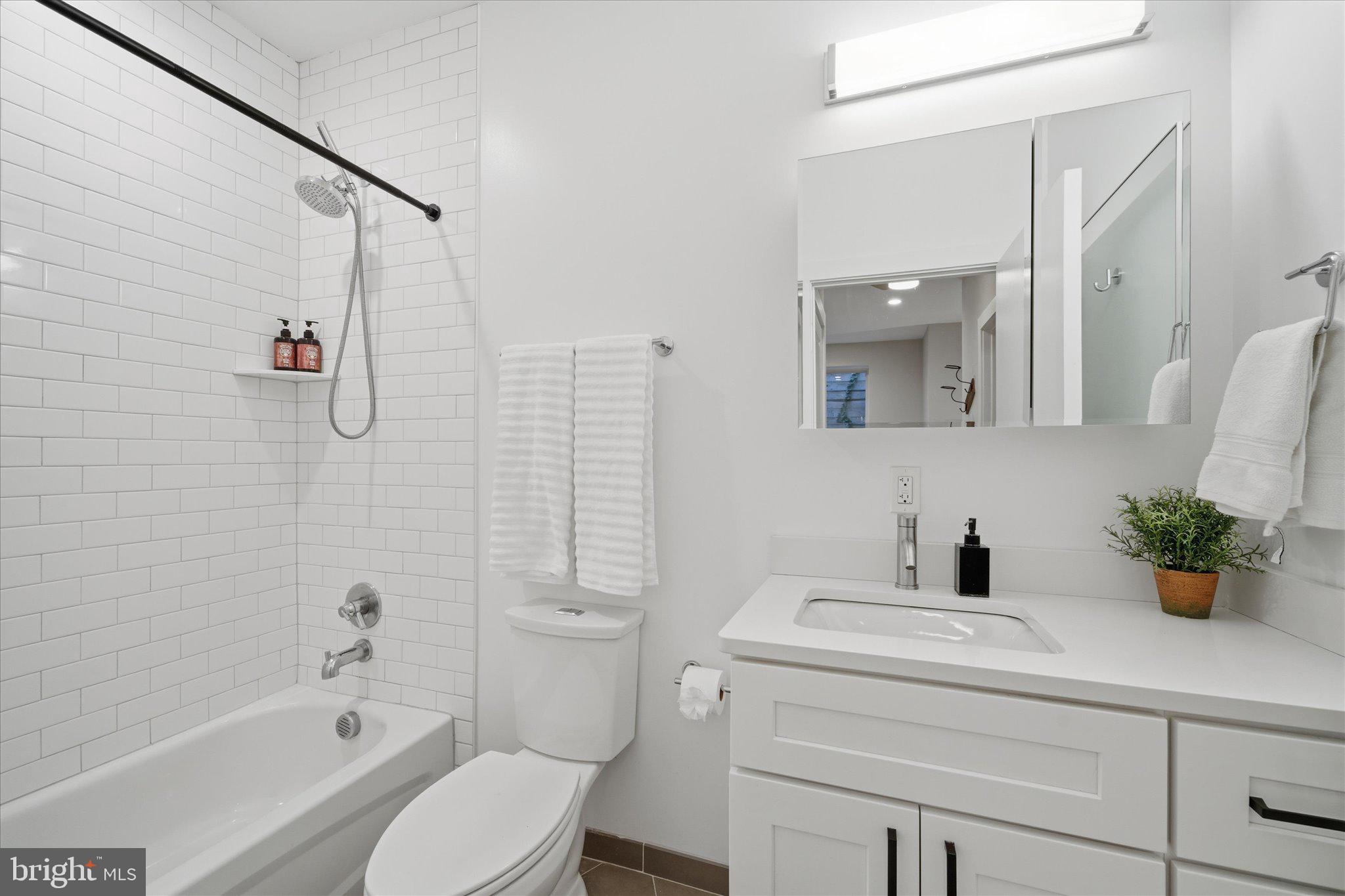 1016 17th Place Northeast, Unit 7 Washington, DC 20002 - Photo 13 of 28 a bathroom with a sink toilet and shower