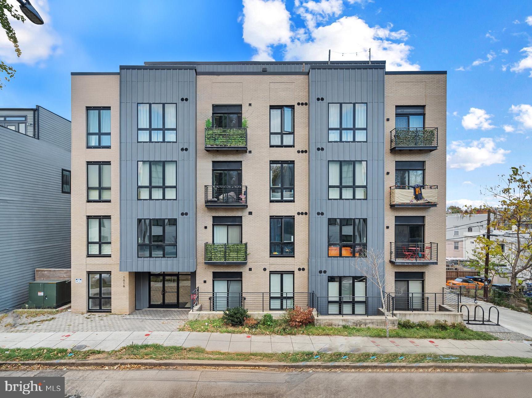 1016 17th Place Northeast, Unit 7 Washington, DC 20002 - Photo 2 of 28 a front view of a building with a yard