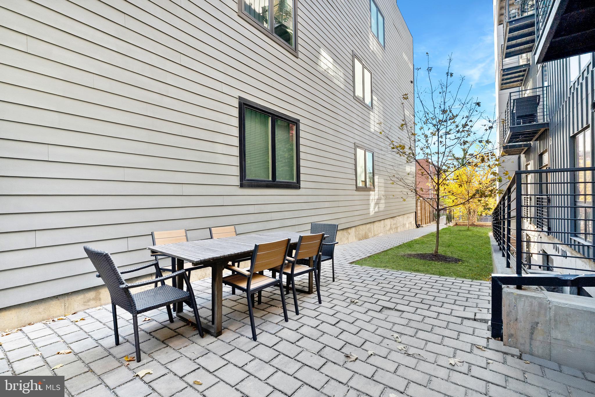 1016 17th Place Northeast, Unit 7 Washington, DC 20002 - Photo 23 of 28 a table and chairs in front of a house
