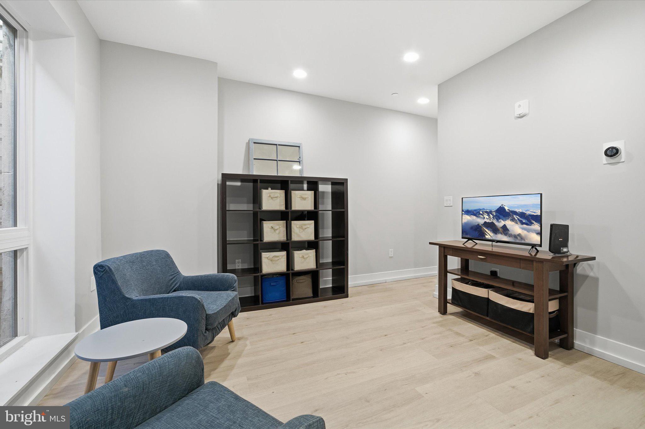 1016 17th Place Northeast, Unit 7 Washington, DC 20002 - Photo 5 of 28 a living room with furniture a piano and a bookshelf
