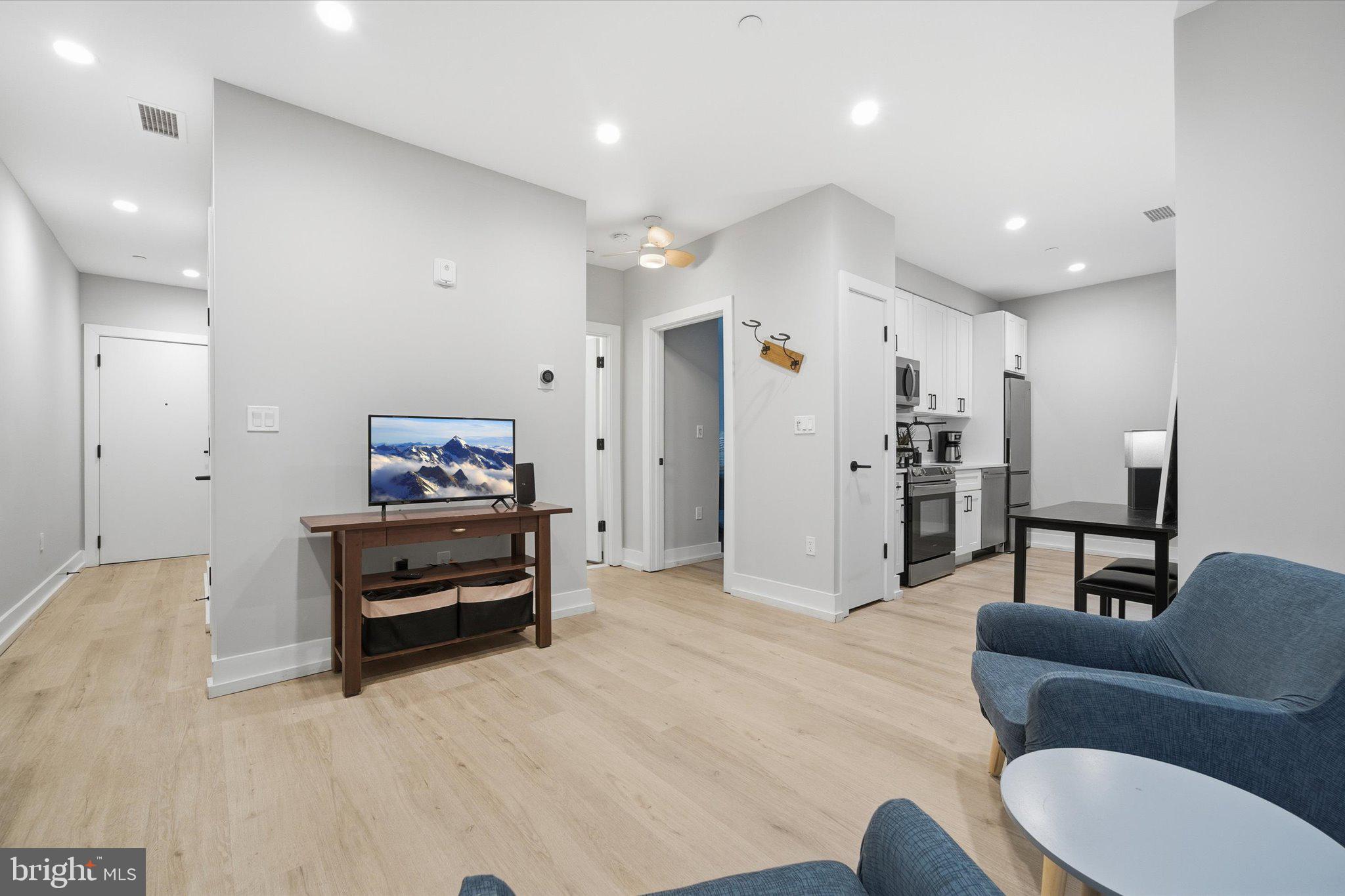1016 17th Place Northeast, Unit 7 Washington, DC 20002 - Photo 6 of 28 a living room with furniture and a flat screen tv