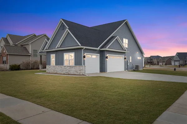 a front view of a house with swimming pool having outdoor seating