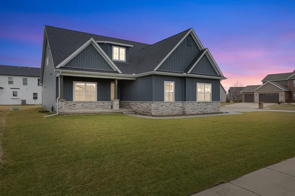 a house view with swimming pool in front of it