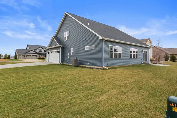 a kitchen with kitchen island granite countertop a stove a sink a center island and a wooden floor
