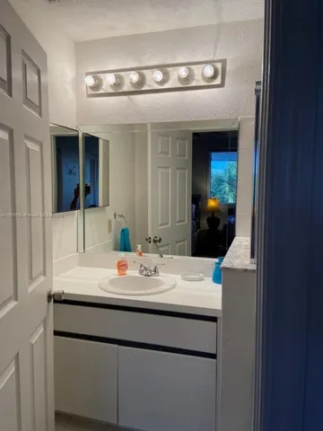 a bedroom with a bed and a mirror