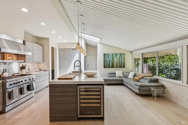 a living room with furniture and floor to ceiling windows