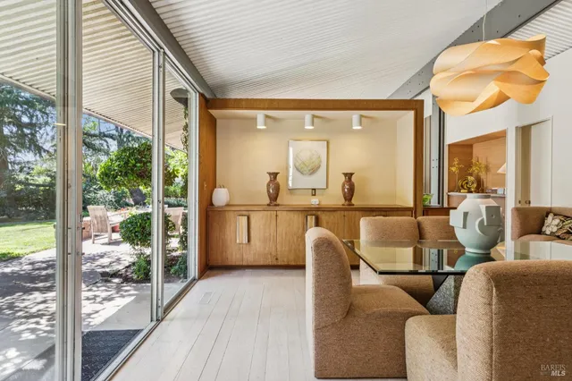 a living room with furniture and a floor to ceiling window