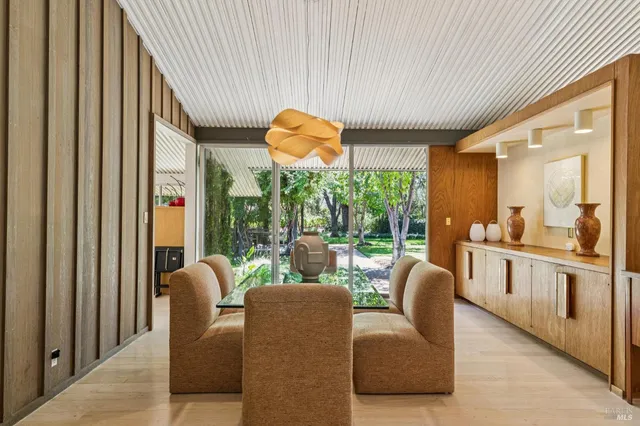 a bedroom with furniture and large windows