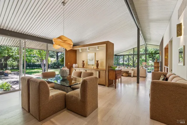 a view of a house with backyard and sitting area