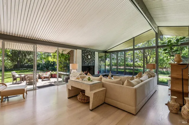 a bedroom with furniture and large windows