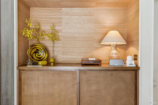 a bedroom with a bed a bookshelf and a large window